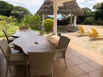 Covered patio with wooden dining table and ocean view Costa Esmeralda Panama