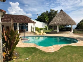 Tropical patio with thatched palapa pool and ocean view in Costa Esmeralda Panama