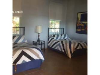 Bedroom with two twin beds large wall art windows Costa Esmeralda Panama