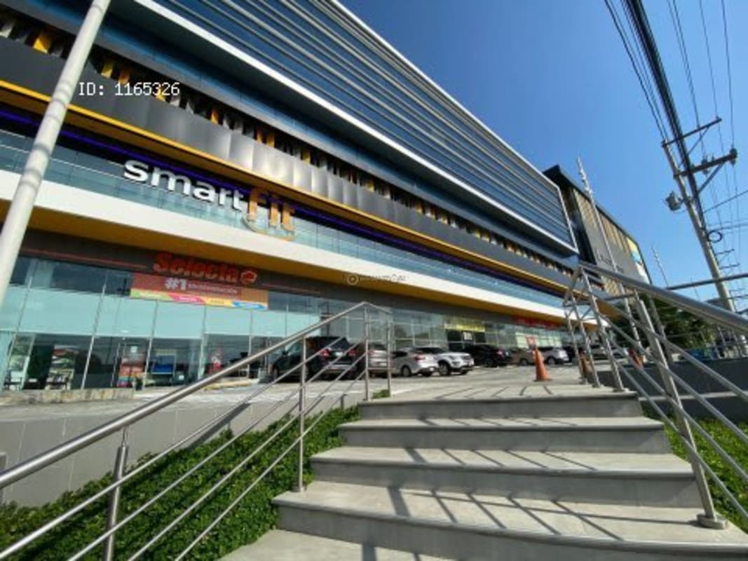 Ground-level glass entrance of commercial space at Dorado City Center Panama City