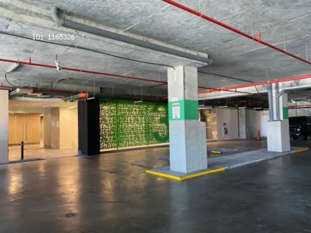 Modern commercial parking garage interior Dorado City Center with concrete finish and color accents