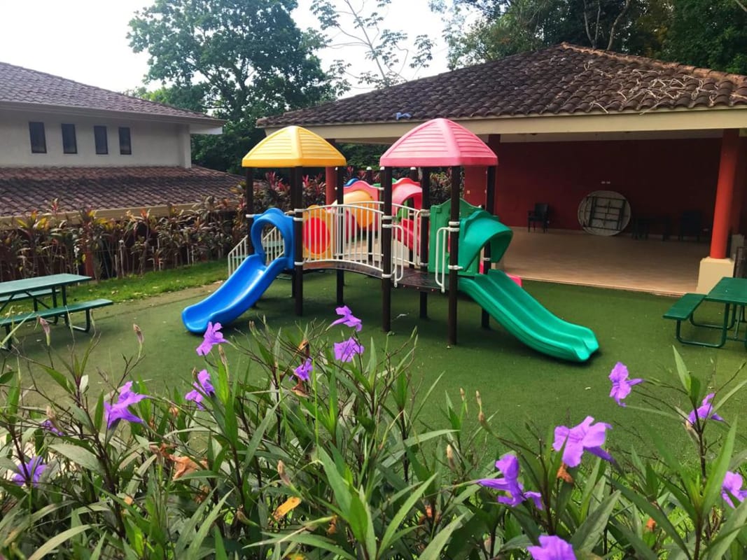 Resort-style swimming pool surrounded by tropical gardens Embassy Club Clayton Panama