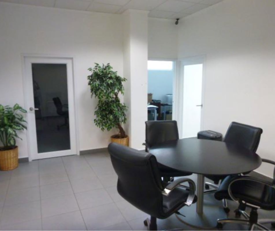Black round conference table with glass door and plants PH Morica Office Panama