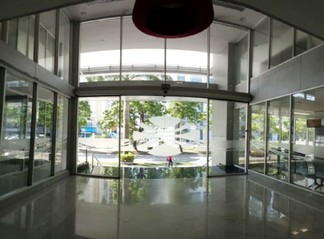 Lobby with glass walls and automatic doors Torre Aseguradora Ancón Costa del Este Panama City