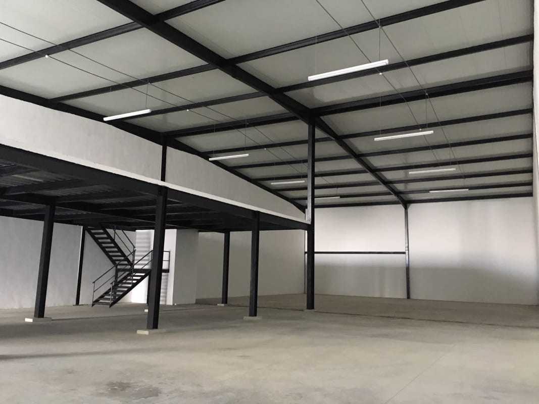 Spacious interior with steel beams, concrete floor, mezzanine at Parque Industrial Las Americas Panama
