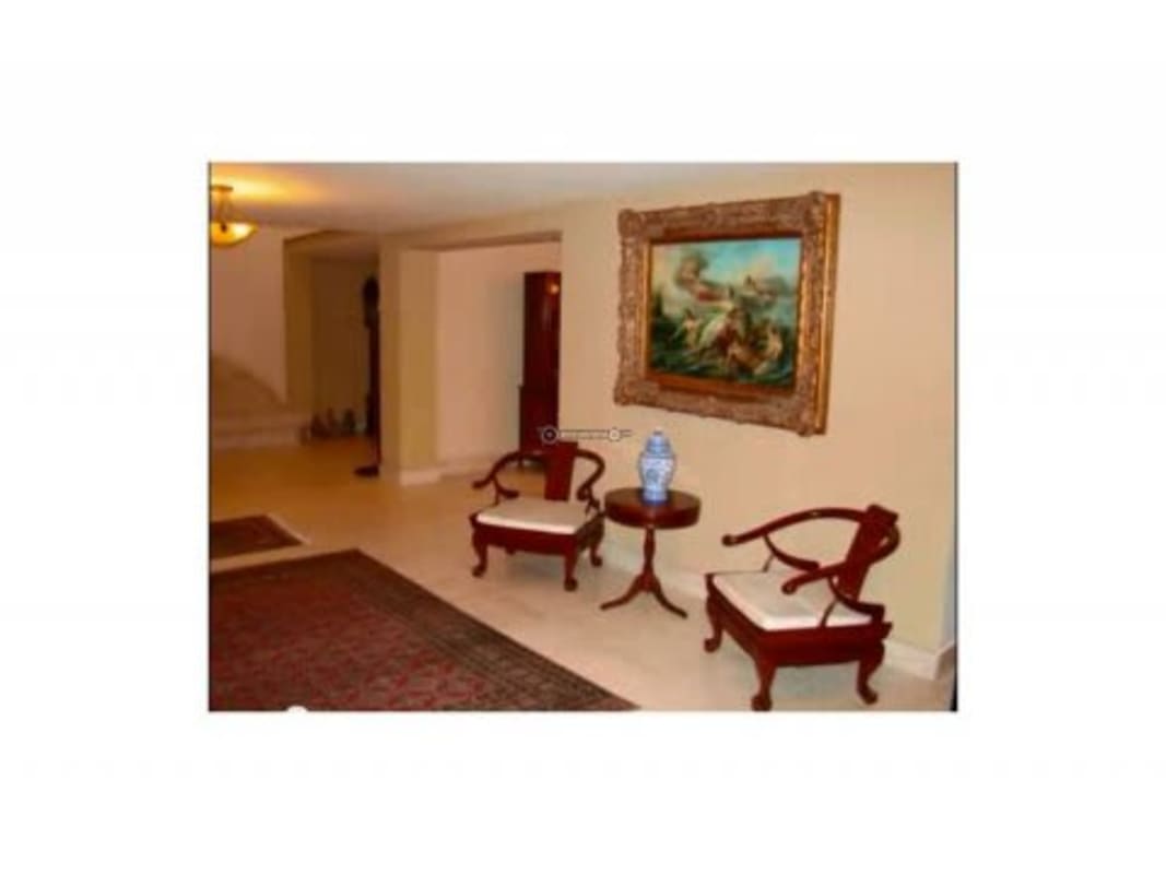 Spacious kitchen with wood cabinetry, granite countertop and large window in Albrook Panama home