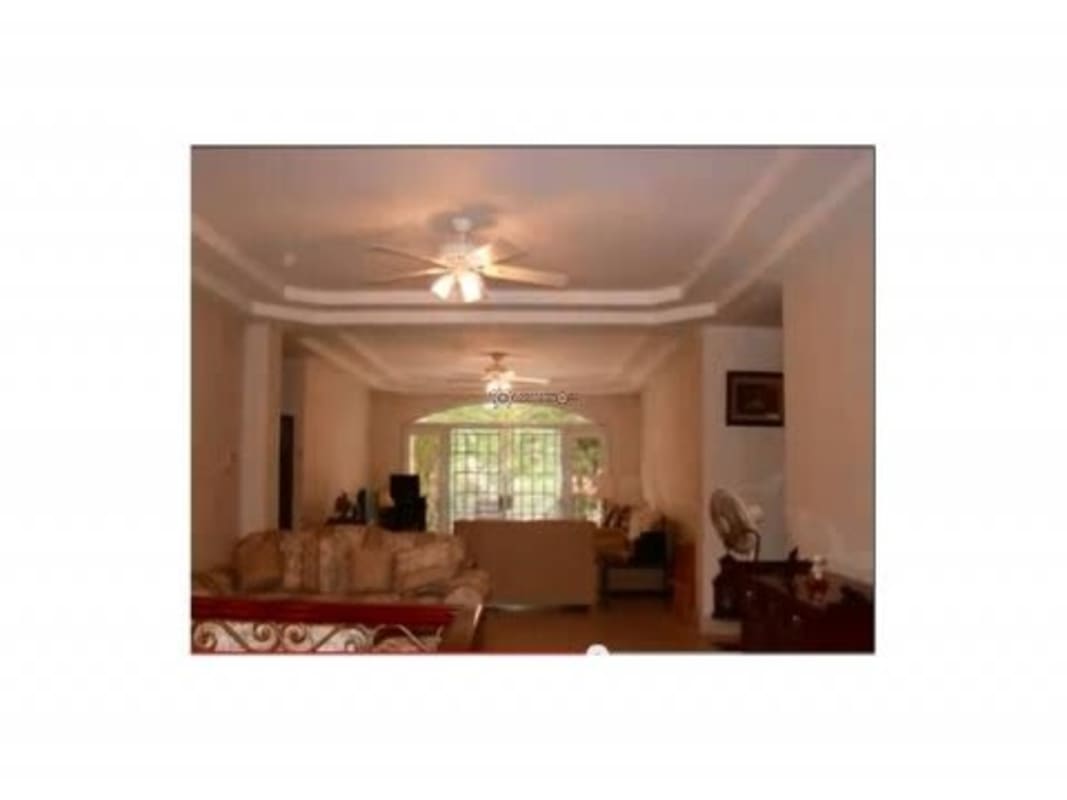 Traditional dining room with window, chandelier lighting, dark wood dining set Albrook residence Panama