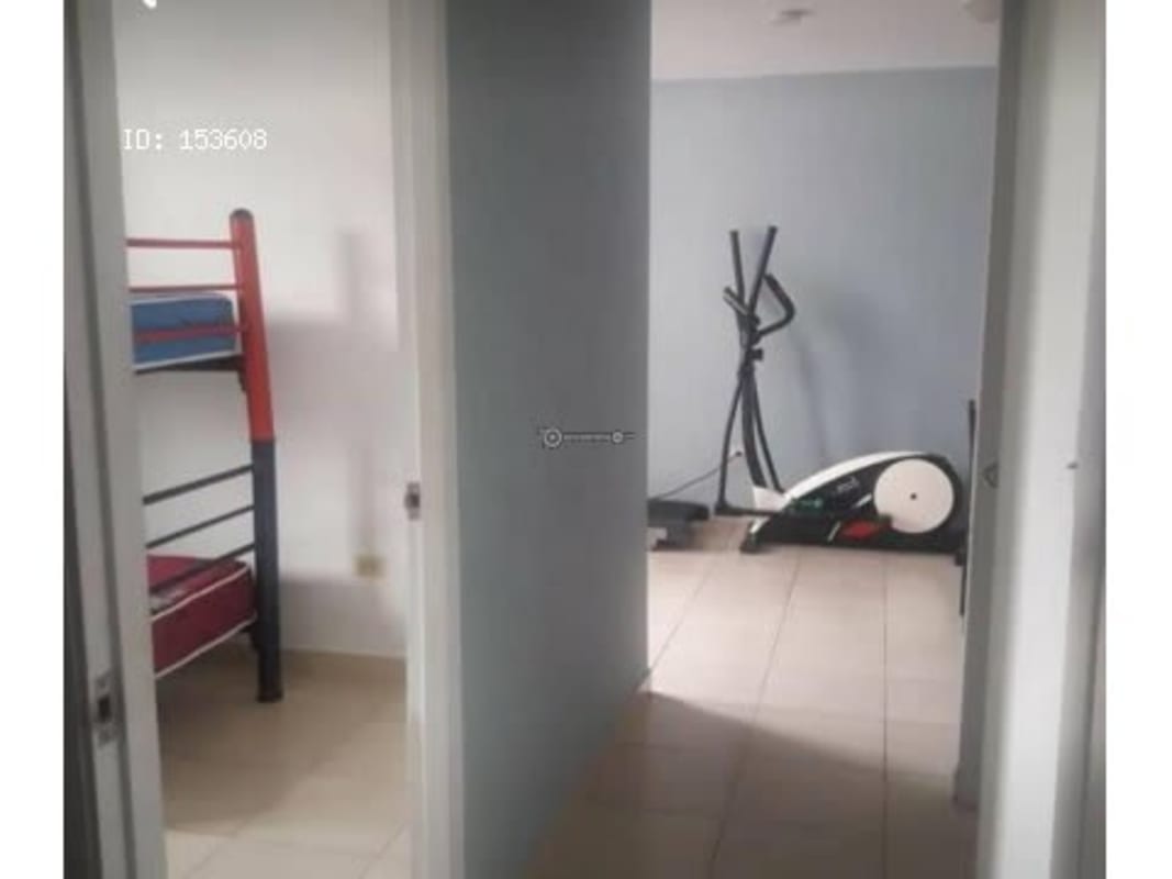 Hallway leading to shared bathroom with colorful shower curtain San Miguelito Panama