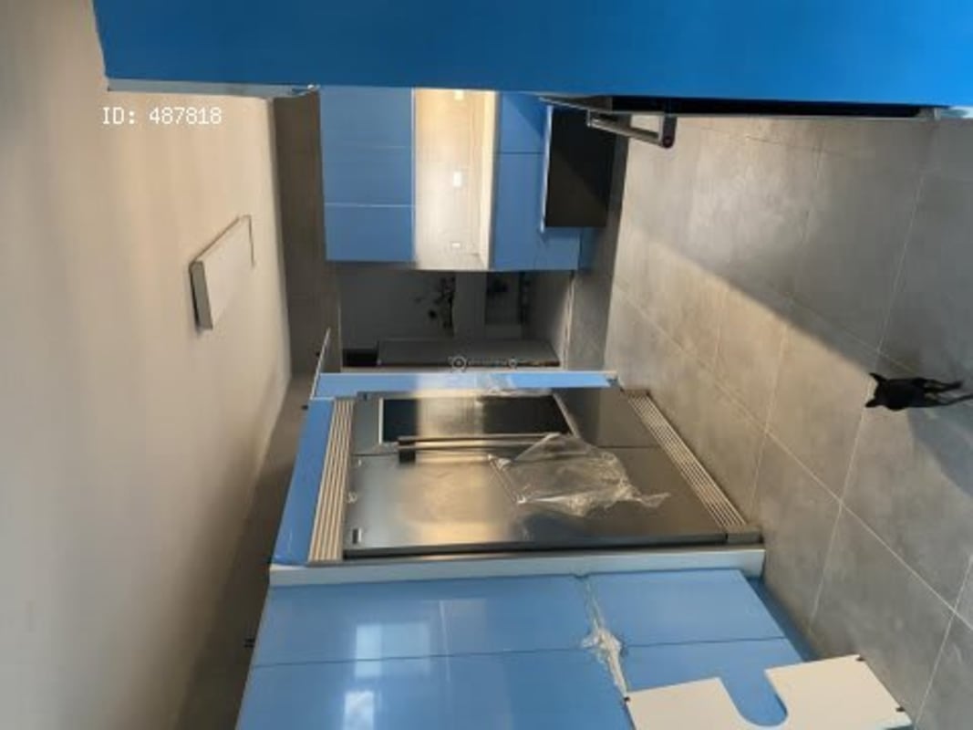 Modern kitchen with blue cabinetry, built-in appliances in Costa Serena house Panama