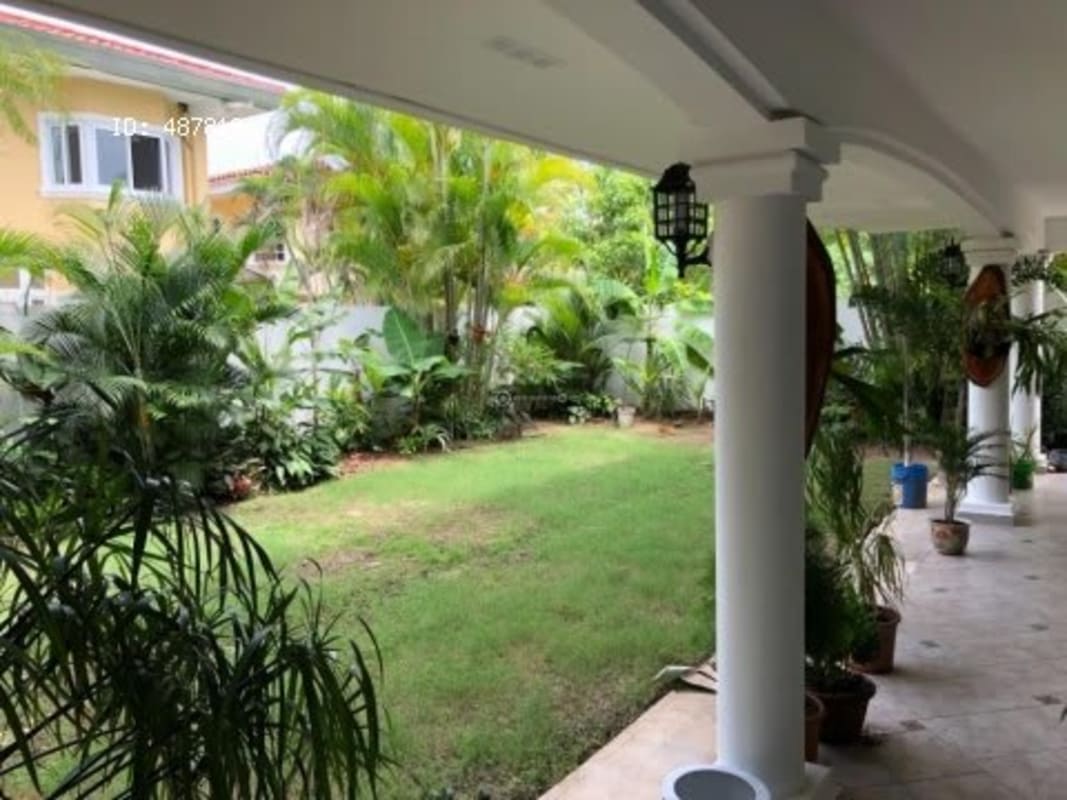 Covered veranda with white columns and garden views in Costa Serena Costa del Este