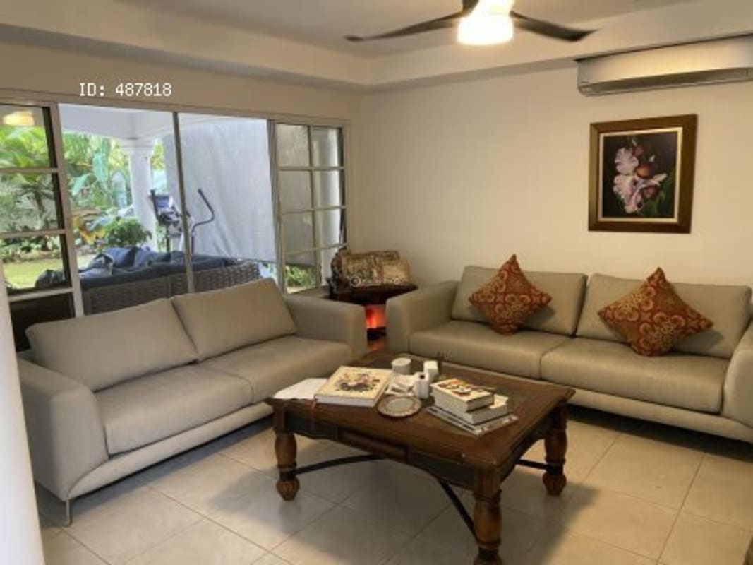 Two beige sofas, coffee table, sliding doors to garden in luxury Costa Serena house