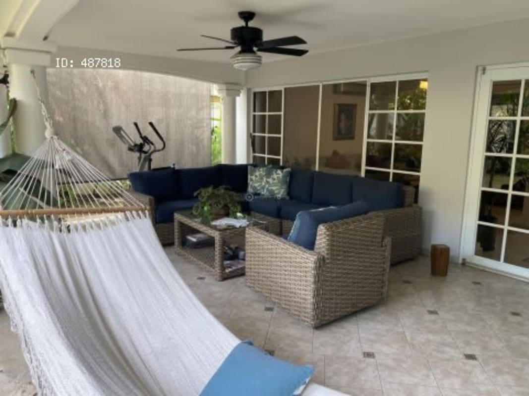 Shaded patio with outdoor sofa and hammock garden view Costa Serena house Panama