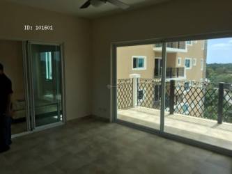 Living room with large sliding glass doors to balcony overlooking golf at PH Alcazar Coronado Panama