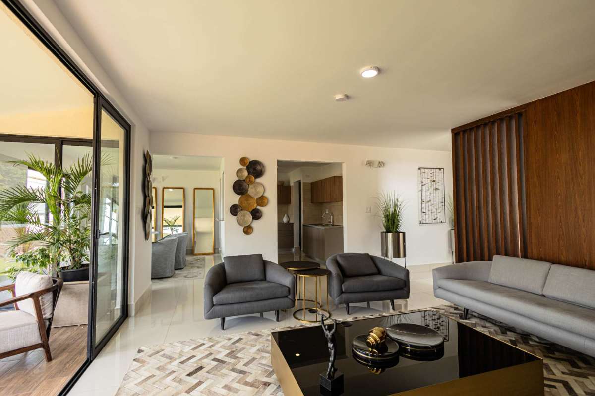 Second bedroom with large window and bright minimalist decor in family home at Arcadia Costa Verde