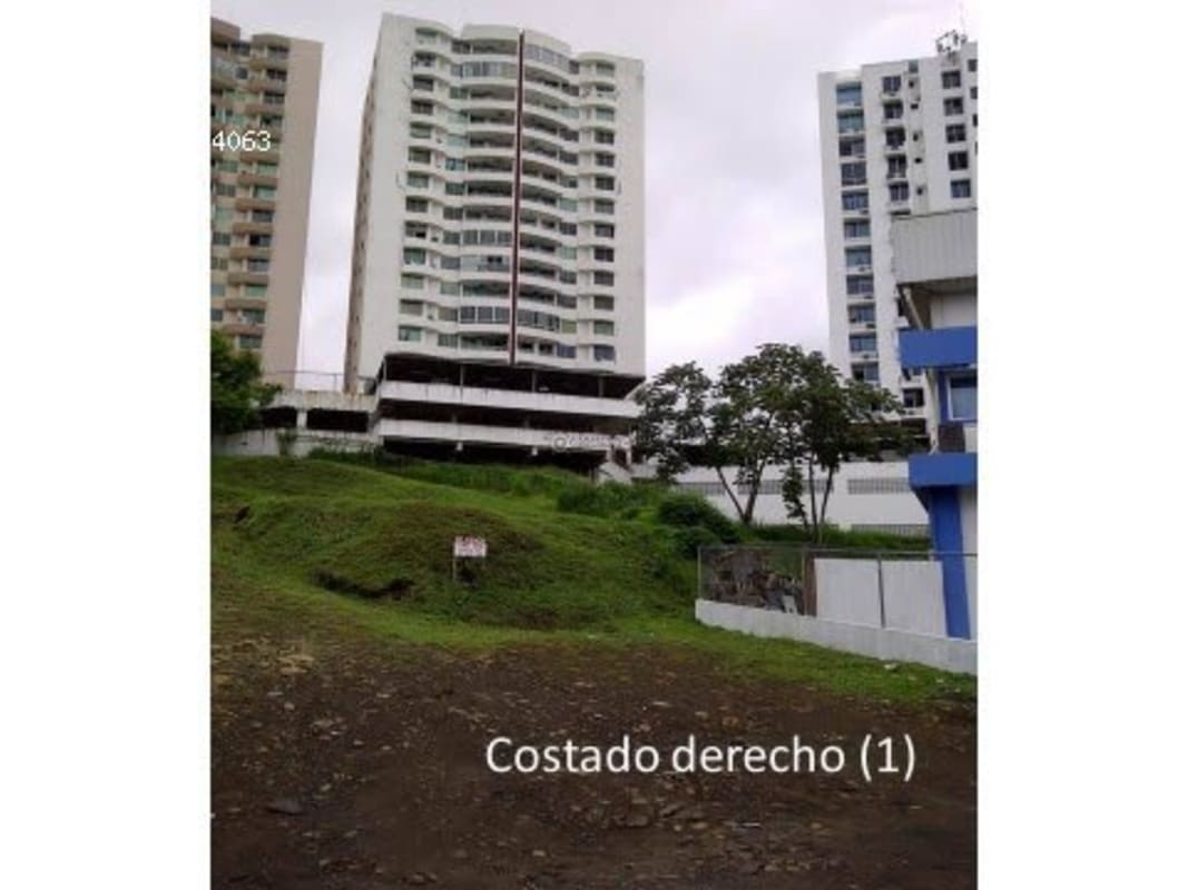 Grassy hillside near modern apartment complexes in Bethania Panama