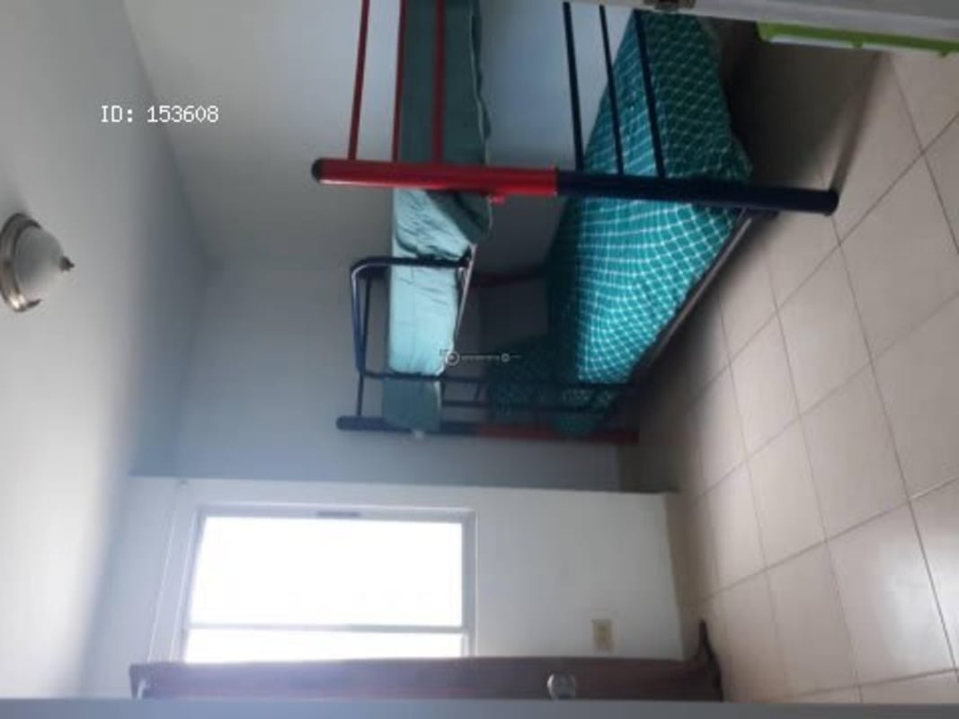 Citywide sunset view from residential apartment showing orange skies and distant skyline