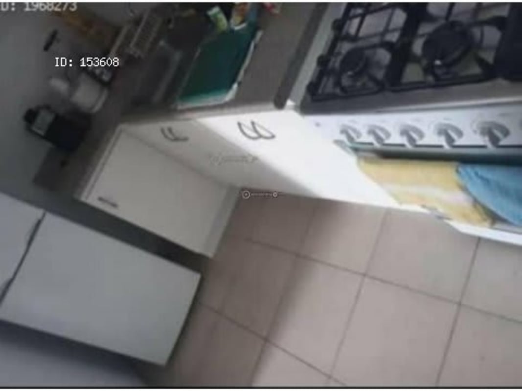 Functional kitchen with white cabinets, gas stove, tile floor in shared apartment Panama City