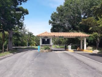 Entrance with tiled roof security booth at Costa Esmeralda San Carlos Panama