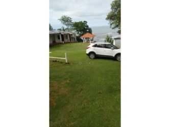Beachfront hostel at Santa Catalina with tropical gazebos and garden facing ocean waves Panama