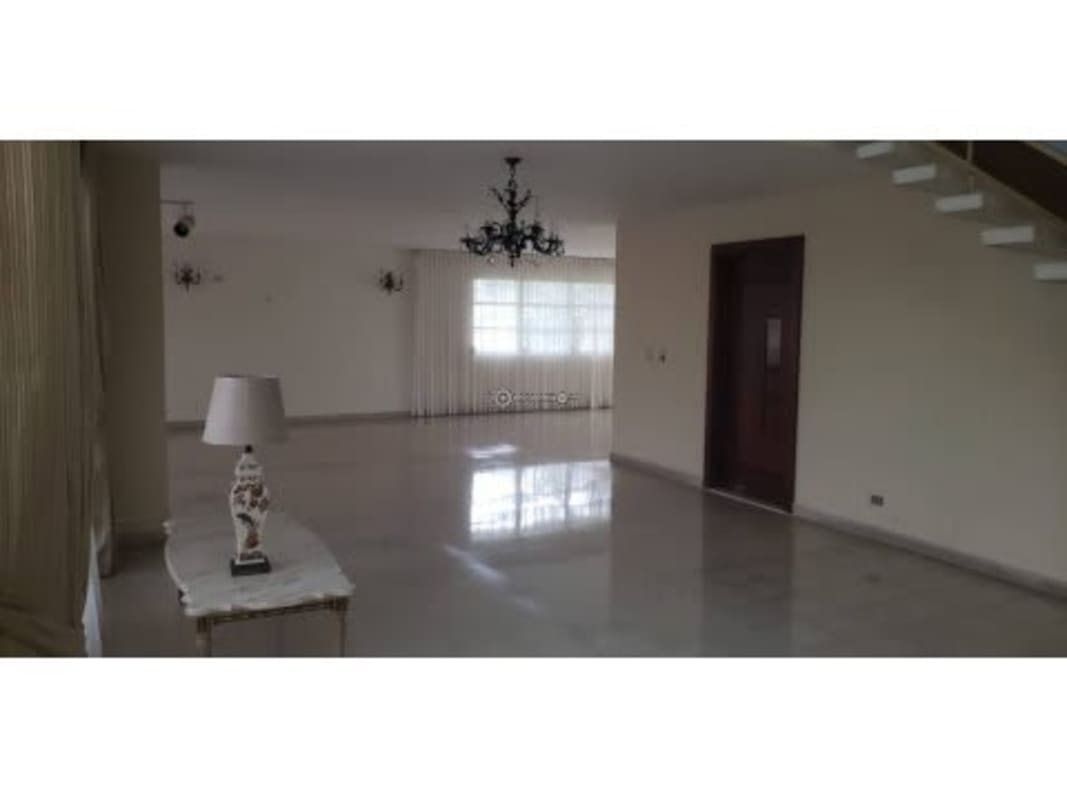 Bright living room with ceramic tile floor windows chandelier Panama house for rent