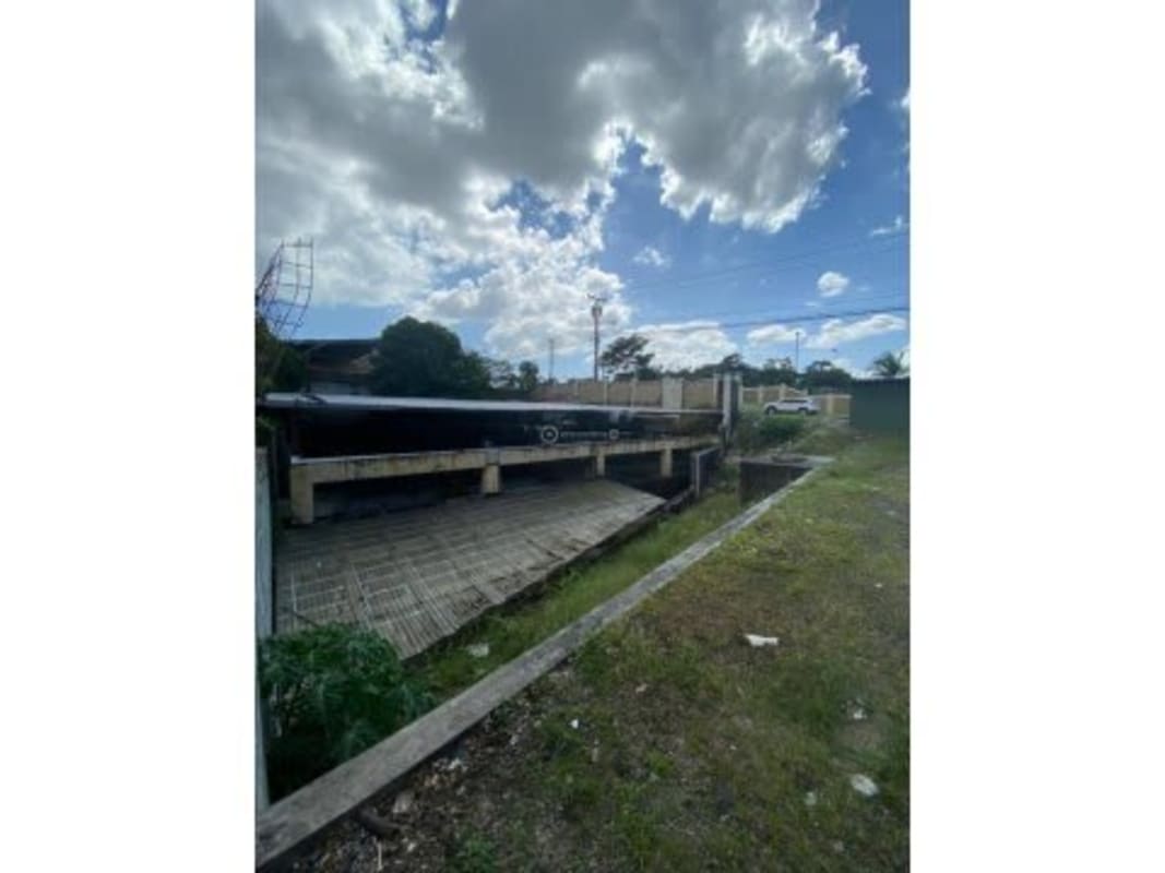 Lot with concrete entry, partial metal roof structure, and cleared space Condado del Rey Panama