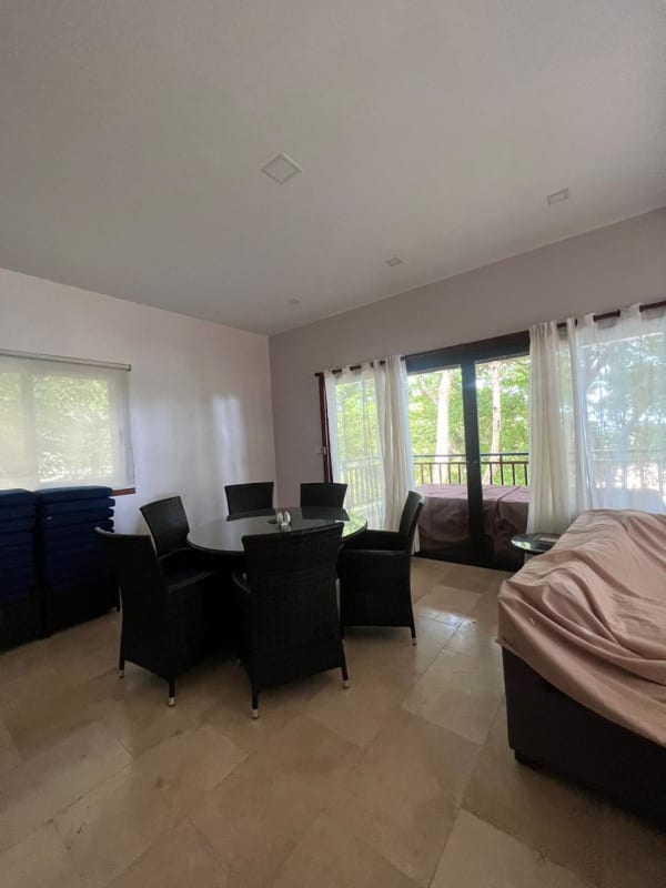 Bright spacious living and dining room with large windows overlooking Saboga beach Panama