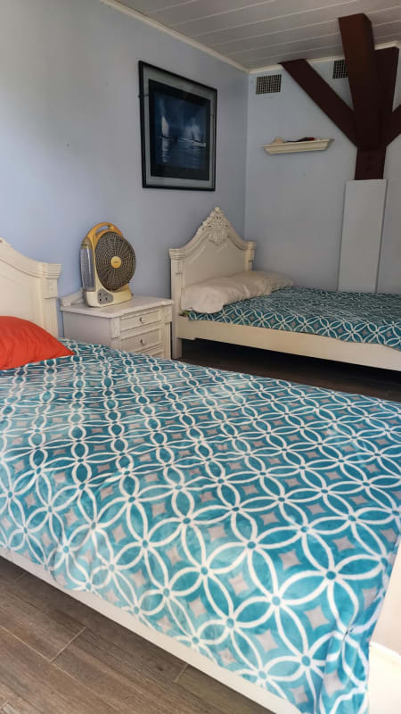 Coastal-themed twin bedroom with blue decor in beachfront villa Saboga Island Panama