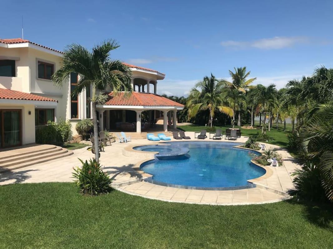 Mediterranean villa with curved pool, palm trees, terrace, tropical gardens Buenaventura Panama