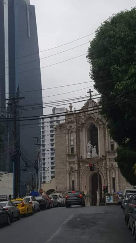 Small kitchenette with wood cabinets, sink, and microwave in PH Plaza Ejecutiva office Panama