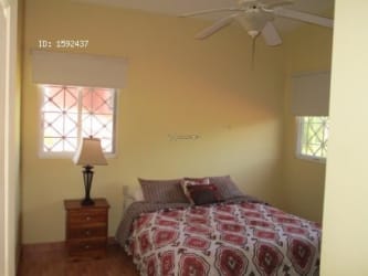 Two-story gated beach house at Playa Malibu with tropical landscaping