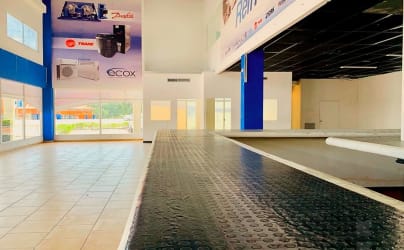 Commercial plaza bathroom with green stall doors, multiple sinks in Coronado Panama