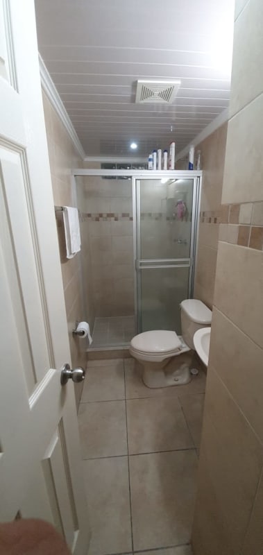 Compact private bathroom shower enclosure tiled walls PH Residencial Las Palmeras Brisas del Golf Panama