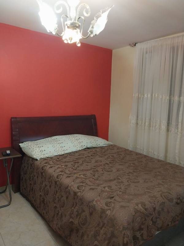 Bedroom with wall-mounted TV wooden closet tile floors PH Residencial Las Palmeras Brisas del Golf Panama