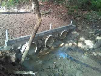 Concrete culverts with muddy water drainage on large rural land in Panama