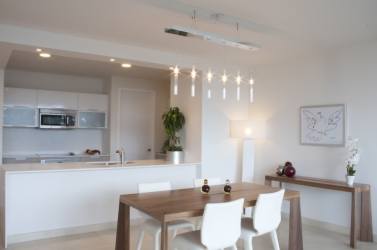 Open plan living dining with floor-to-ceiling glass and ocean views in PH Casa Bonita Playa Bonita Panama