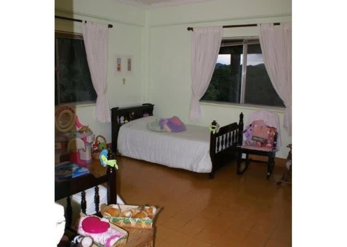 Bright child's bedroom with wooden bed, double windows, mountain view, hardwood floor Clayton house