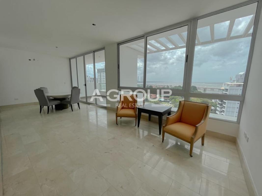 Spacious master bedroom with marble floors and ocean view window at PH Panorama Coco del Mar Panama