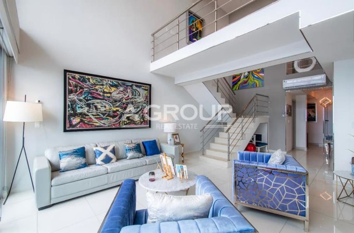 Modern kitchen with marble island, stainless appliances and ocean view in Icon Tower penthouse Panama