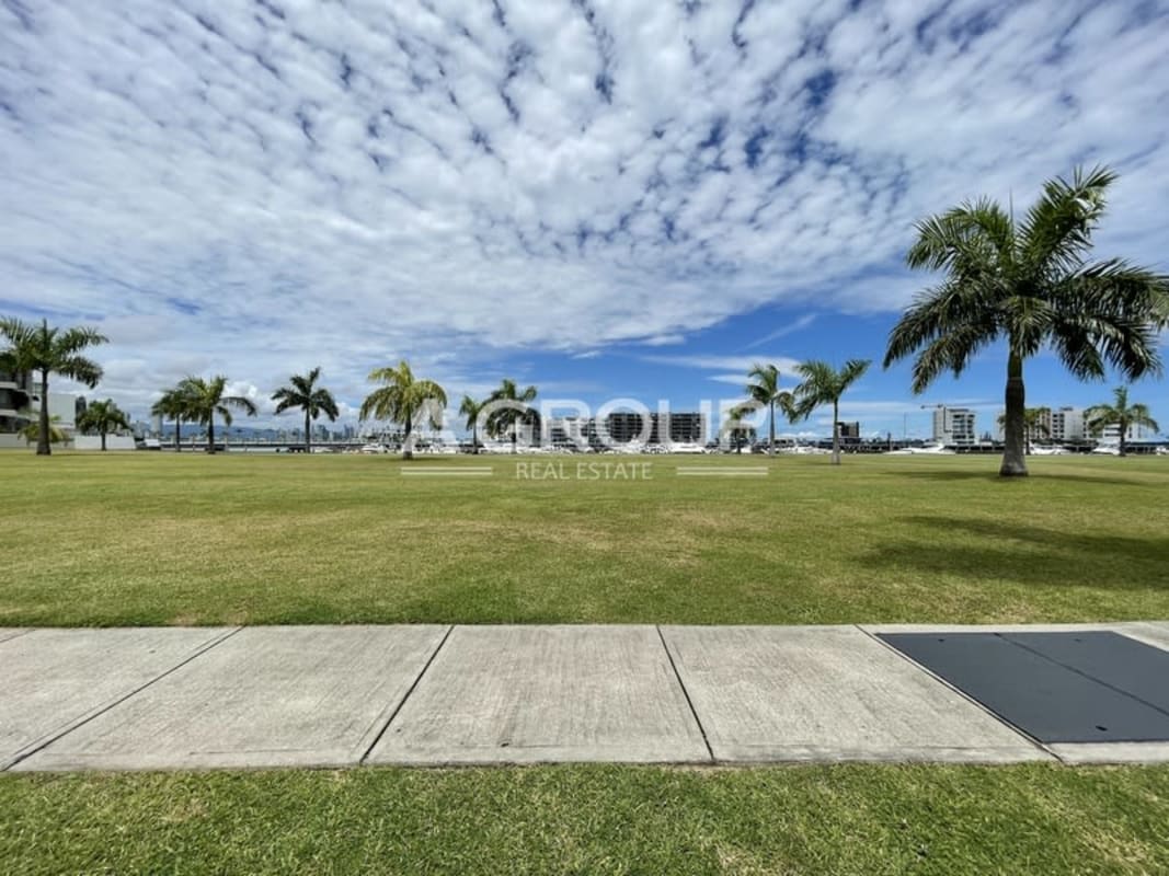 Lush waterfront lawn with palm trees marina and Panama City skyline view Ocean Reef