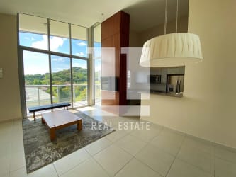 Open concept kitchen with granite counters and breakfast bar in PH Mosaic Panama Pacifico apartment
