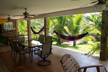 Shaded tropical terrace with hammocks and lush garden Costa Esmeralda San Carlos Panama