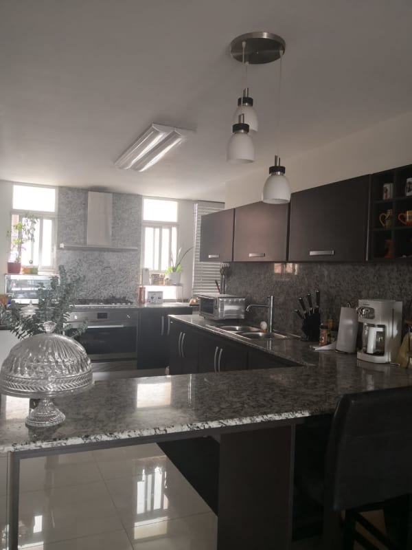 Kitchen with stainless steel appliances and granite counters in PH Villa de las Fuentes Panama City