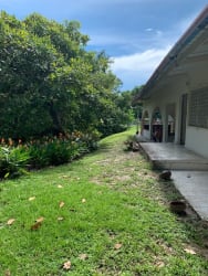 Outdoor covered terrace overlooking lush backyard at Coronado Panama beach house