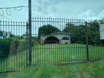 Exterior of single-story home with fenced yard and garden in Coronado near Playa Serena