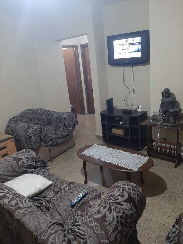 Living room with TV, patterned furniture, and coffee table in PH Los Nazareth Tumba Muerto Panama City