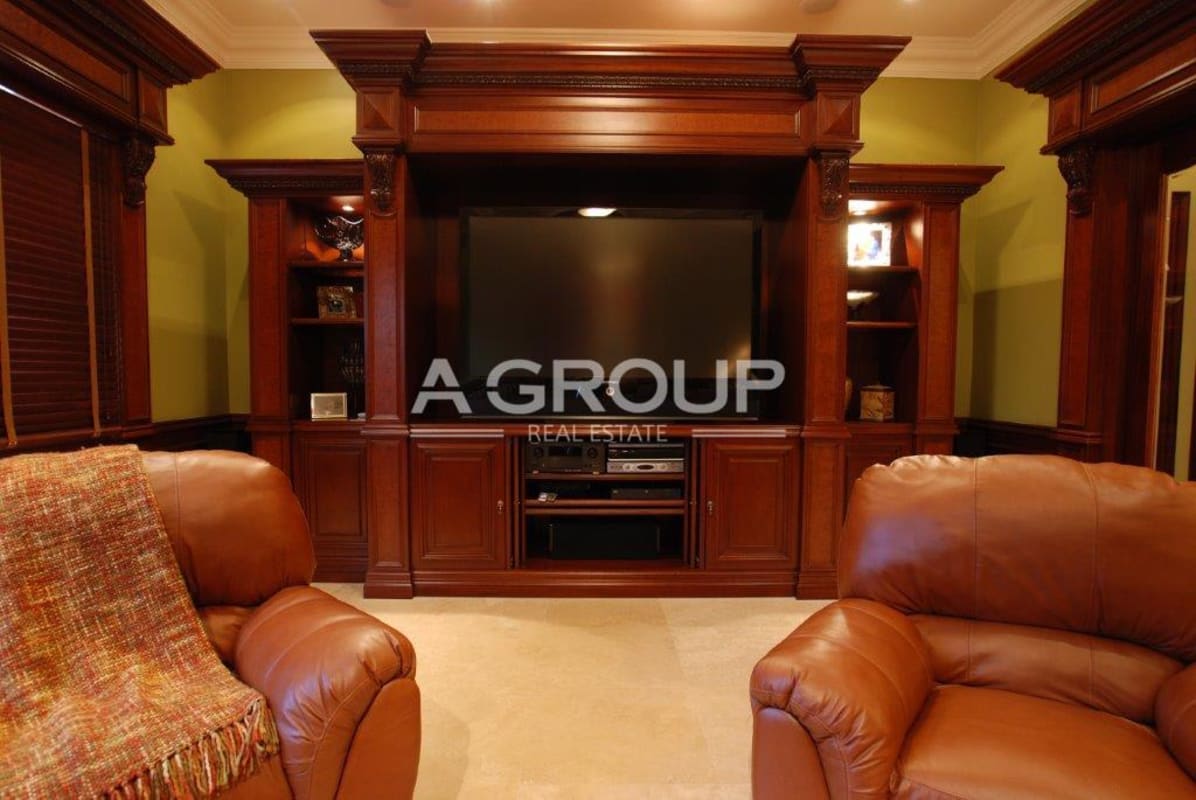Spacious media room with custom wooden entertainment center and large TV Costa del Este Panama