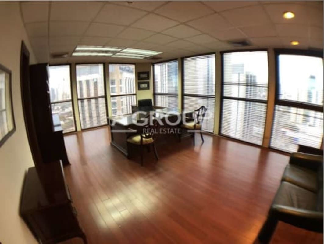 Corner office area with hardwood floors, large windows and panoramic city views at Humboldt Tower Panama
