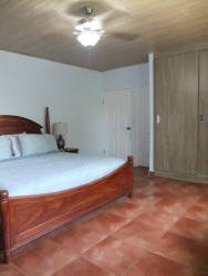 Bedroom with ceramic tile floor and wooden furniture in Coronado beach house