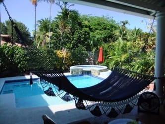 Traditional bohio tiki hut outdoor bar by pool Paseo Las Lajas Coronado