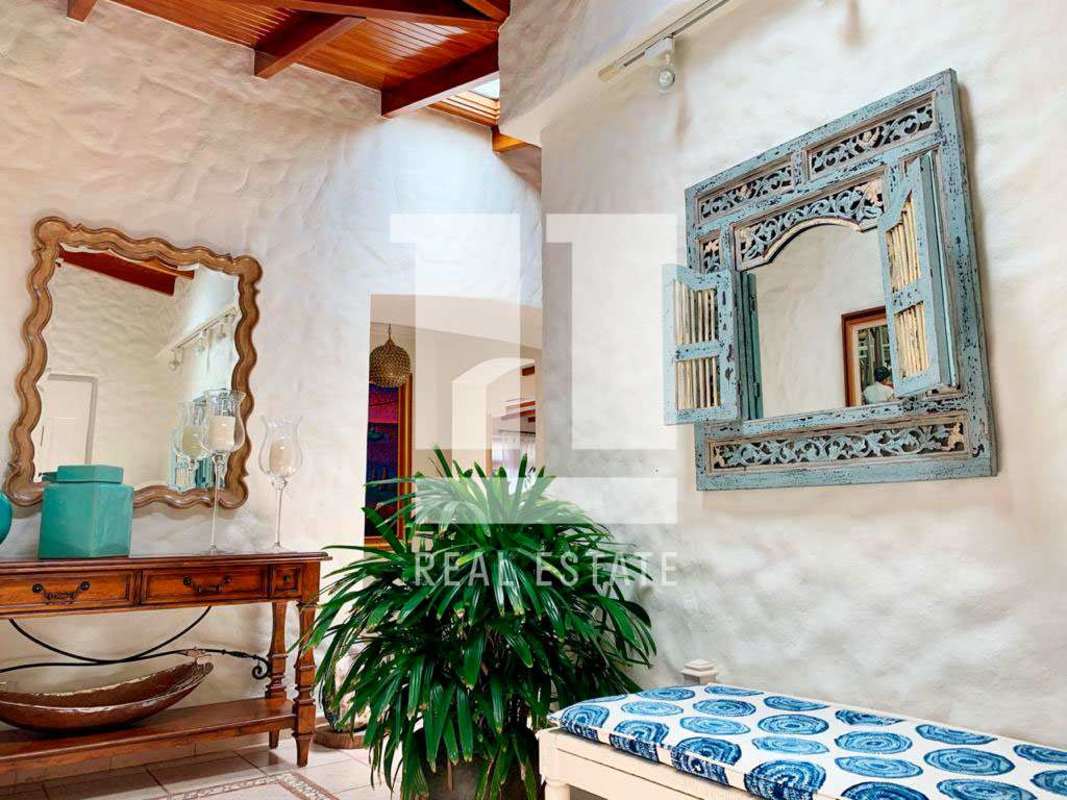 Bright living room with wood ceilings, panoramic ocean windows and luxury coastal decor Coco del Mar Panama